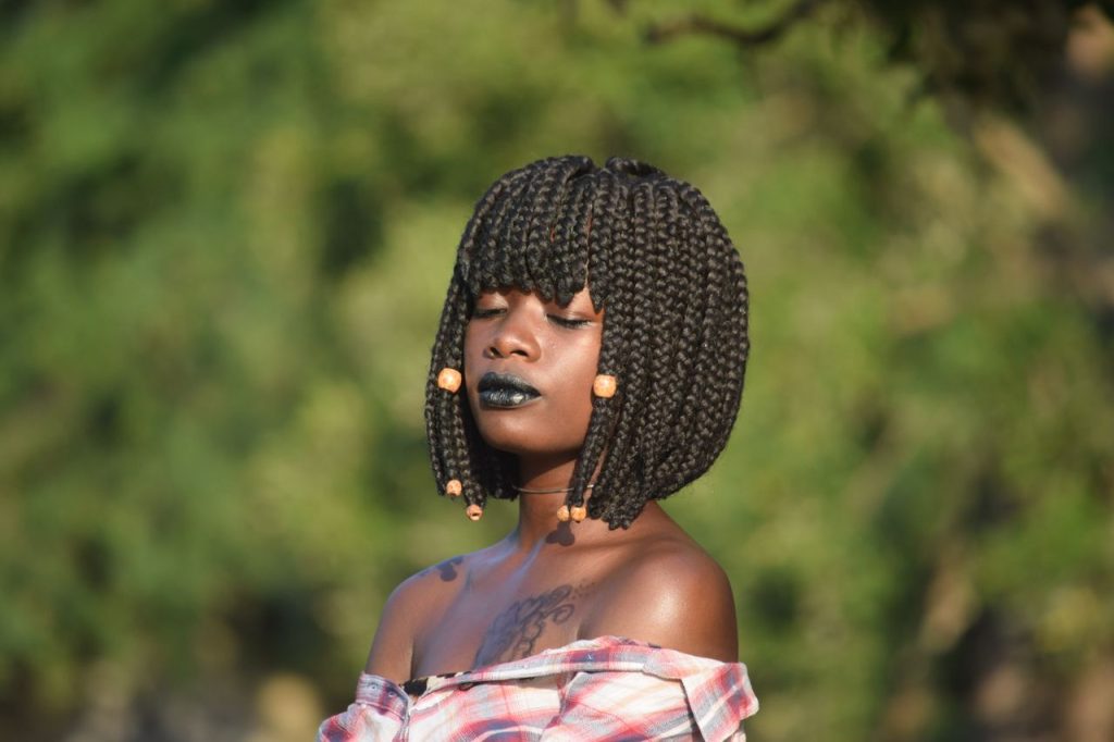 Beautiful portrait of a woman with braided hair and black lipstick in Mombasa, Kenya.